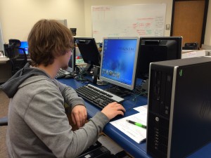 Scott McDermott is working on a computer, in the process of logging in